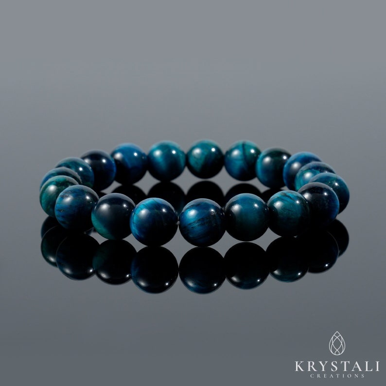 May include: A blue tiger's eye gemstone bracelet with round beads. The bracelet is made of natural stones and is a popular choice for jewellery.