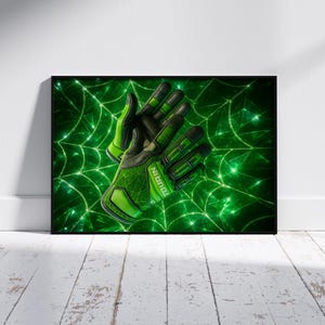 May include: A framed print featuring a pair of green and black gloves, likely for sports. The gloves are set against a vibrant green background with a web-like design. The word "TOURIN" is visible on one glove.
