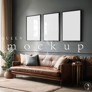 May include: Three black framed pictures hanging on a dark grey wall above a brown leather sofa with cushions. The sofa is in a living room with a potted plant and a wooden side table.