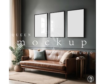 May include: Three black framed pictures hanging on a dark gray wall above a brown leather sofa with pillows. The sofa is in a living room with a potted plant and a wooden side table.