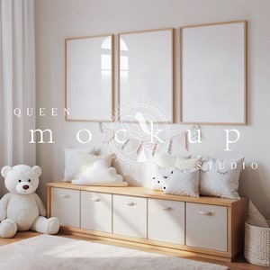 May include: A nursery scene with three framed blank art prints above a wooden storage unit. The unit holds pillows with cloud and sleepy eye designs, a teddy bear, and a fluffy rug. The text "QUEEN mockup STUDIO" is visible.