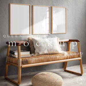May include: Three framed pictures with white mats and light wood frames hang on a gray wall above a light brown wicker bench with a white pillow. The bench has a dark brown wooden armrest and legs. A small round light brown woven ottoman sits in front of the bench.