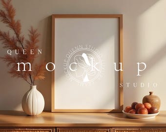 May include: A wooden framed mockup with the text "QUEEN mockup STUDIO" and a white vase with dried plants. A bowl of peaches and a small wooden vase are on a wooden cabinet with woven drawers.