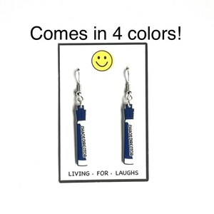 May include: A pair of silver dangle earrings with blue and white charms that say "Chaos Director". The earrings are displayed on a white card with a smiley face and the text "Comes in 4 colors!" and "Living. For. Laughs."