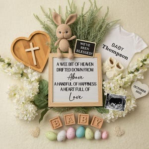May include: A white letter board with the text "A wee bit of heaven drifted down from Above A handful of happiness A heart full of Love" surrounded by white flowers, a wooden heart with a cross, a small stuffed bunny, a white onesie with the text "Baby Thompson", a small chalkboard with the text "We've been blessed!" and a small ultrasound image.
