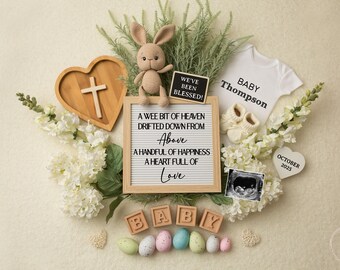 May include: A white letter board with the text "A wee bit of heaven drifted down from Above A handful of happiness A heart full of Love" surrounded by white flowers, a wooden heart with a cross, a small stuffed bunny, a white onesie with the text "Baby Thompson", a small chalkboard with the text "We've been blessed!" and a small ultrasound image.
