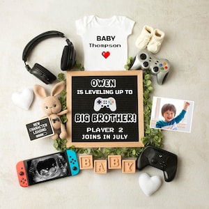 May include: A gender reveal announcement with a chalkboard sign that reads "Owen is leveling up to Big Brother! Player 2 joins in July". There are baby booties, a onesie that says "Baby Thompson", a video game controller, a stuffed bunny, and a sonogram image.