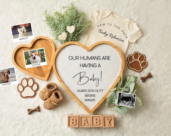 May include: A wooden heart-shaped sign with the text "Our humans are having a Baby! Guard dog duty begins Apr/25".  The sign is surrounded by dog photos, a baby onesie, and wooden blocks that spell "BABY".
