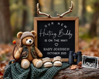 May include: A brown teddy bear wearing a camouflage vest and holding a bow and arrow sits on a green blanket with a black letter board that reads "Our New Hunting Buddy is on the way! Baby Johnson October 2025".