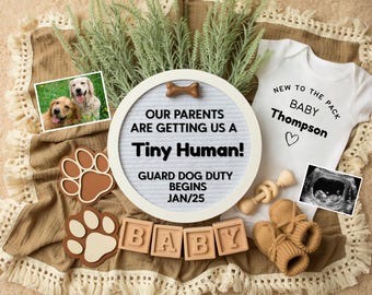 May include: A white letter board with the text "Our parents are getting us a Tiny Human! Guard dog duty begins Jan/25".  Two brown paw print shapes, a white baby onesie with the text "New to the pack Baby Thompson", and a wooden rattle are on a brown blanket with white fringe.  There is a photo of two golden retrievers and a sonogram image.