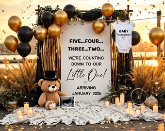 Puede incluir: Una escena de anuncio de embarazo con globos dorados y negros, un oso de peluche y un letrero que dice "FIVE...FOUR...THREE...TWO...WE'RE COUNTING DOWN TO OUR Little One! ARRIVING JANUARY 2026." Un body de bebé está colgado.