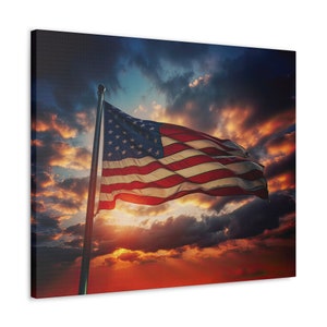 May include: An American flag waving in the wind against a dramatic sunset sky with clouds. The flag is red, white, and blue with stars on the blue field.