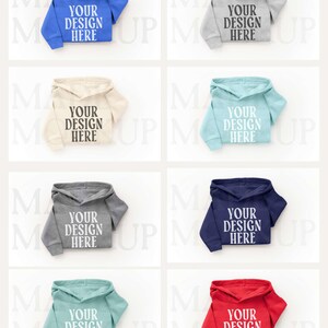 May include: Eight hooded sweatshirts in different colours, such as blue, grey, beige, and red. Each sweatshirt features the text "YOUR DESIGN HERE" on the front. The sweatshirts are presented against a white backdrop.