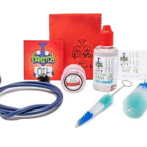 May include: A tuba care and cleaning kit with a red cleaning cloth, a blue cleaning snake, two cleaning brushes, a small jar of tuning slide grease, a bottle of Eco Pro valve oil, and a card with the Monster Oil logo.
