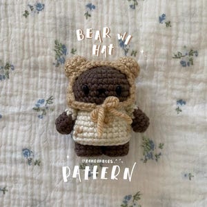 May include: Crochet pattern for a brown bear wearing a beige hat. The pattern is called "Bear with Hat" and is by @bondingbuds.