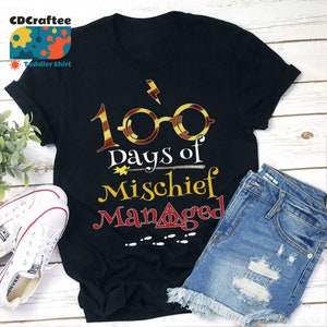 May include: Black t-shirt with a graphic of a pair of glasses with a lightning bolt, the text "100 days of mischief managed", a wand, and a set of footprints.