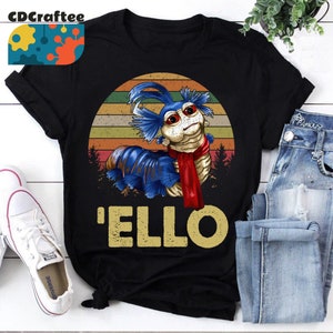 May include: A black t-shirt with a retro-style illustration of a blue and red worm with the text 'ELLO' underneath.