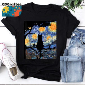 May include: Black t-shirt featuring a silhouette of a cat perched on a branch against a starry night sky painting. The painting is reminiscent of Vincent van Gogh's "Starry Night" artwork.