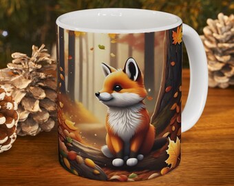 May include: A white ceramic mug featuring a colourful illustration of a fox sitting on a tree branch in a woodland setting. The fox is orange and white with a bushy tail. The background depicts brown trees and fallen leaves.