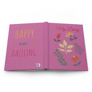 May include: Pink diary with the text "Happy and Dazzling" on the front cover and "My Diary" on the back cover. The back cover also features a floral design with green leaves and yellow, red, and orange flowers.