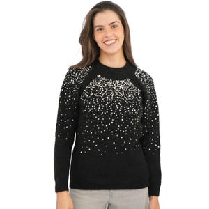 May include: Black sweater with a round neck and long sleeves, adorned with silver sequins. The sequins fade down from the shoulders. The model is wearing grey trousers.