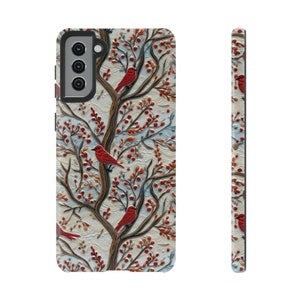 May include: A phone case with a white background and a pattern of red birds and branches with red berries.