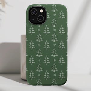 May include: A green phone case with a white outline of Christmas trees and snowflakes pattern.