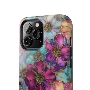 K&ouml;nnte beinhalten: Eine Smartphone-H&uuml;lle mit einem lebendigen Blumenmuster aus tief magentafarbenen, violetten und t&uuml;rkisfarbenen Bl&uuml;tenbl&auml;ttern, die mit metallisch goldenen Linien umrandet sind. Das Design bedeckt die R&uuml;ckseite des Ger&auml;ts und umgibt das schwarze Kameramodul.