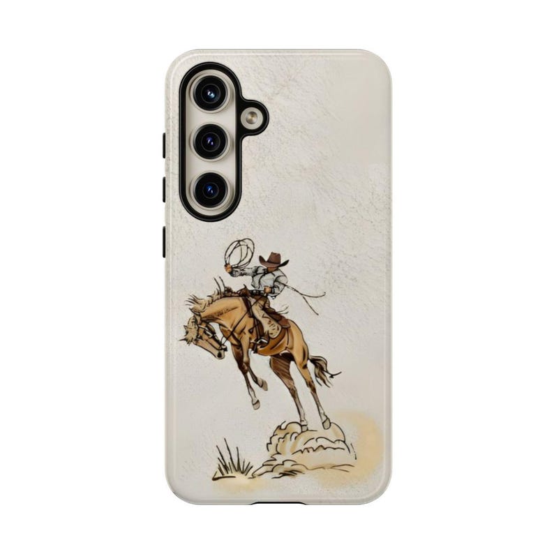 May include: A white phone case with a brown and white illustration of a cowboy riding a bucking horse. The cowboy is wearing a hat and holding a rope.