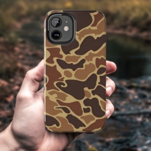May include: A brown, black, and tan camouflage phone case for an iPhone.