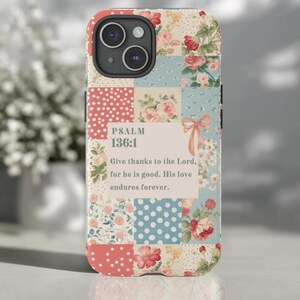 May include: A smartphone case featuring a patchwork design of floral patterns and polka dots in shades of red, blue, and cream. A central rectangular cream panel displays the text: PSALM 136:1 Give thanks to the Lord, for he is good. His love endures forever.