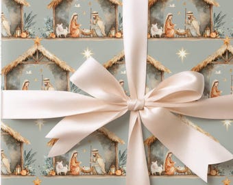 May include: Wrapping paper with a repeating watercolor nativity scene pattern on a sage green background, featuring a stable, figures, and stars. A wide, smooth, pale cream-colored satin ribbon is tied in a large bow across the center.