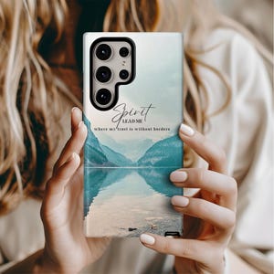 May include: A phone case with a blue and white watercolor landscape and the text "Spirit Lead Me where my trust is without borders".