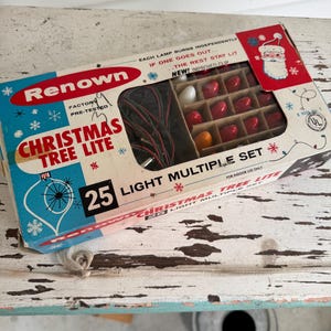 May include: Vintage Renown Christmas Tree Lite set in its original box. The box features a Santa Claus illustration and text that reads "25 Light Multiple Set." The box contains red and white light bulbs.