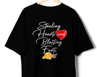 May include: Black t-shirt with white text that reads "Stealing Hearts and Blasting Farts" with a red heart and a cartoon emoji of a face blowing a fart.