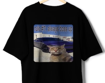 May include: Black t-shirt with a graphic print of a cat sitting in front of a blue car. The text "rule #1: always boss up" is printed above the image.