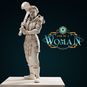 Könnte beinhalten: Weiße bemalte Figur einer weiblichen Ork-Kriegerin, die eine große Axt hält. Die Figur steht auf einem weißen Sockel. Der Text "DND IS A WOMAN" ist in goldenen Buchstaben auf blauem und goldenem Hintergrund.