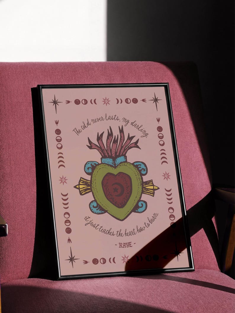May include: Framed art print featuring a heart design with a central heart shape, surrounded by a green and blue outline. The artwork includes text that reads "The old never lasts, my darling, it just teaches the heart how to burn." The print is in a black frame.