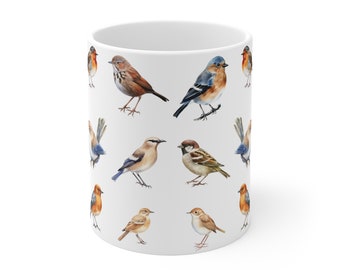 May include: White ceramic mug featuring a repeating pattern of various watercolor bird illustrations. The birds are depicted in shades of brown, blue, orange, and tan. The mug has a standard cylindrical shape and a white background.
