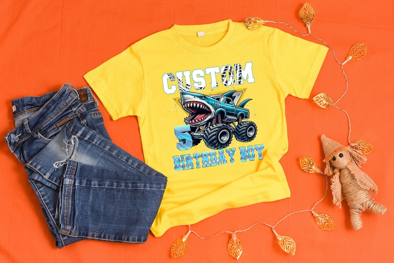 May include: Yellow t-shirt with a blue monster truck graphic and the text "Custom 5 Birthday Boy".