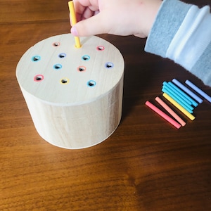 Montessori wooden posting box to practice fine motor skills. Kids 16 months and older.