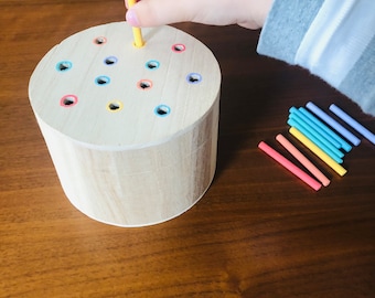 Wooden peg posting box Montessori toddler fine motor skills toy pastel rainbow colors. For kids 16 months and older.