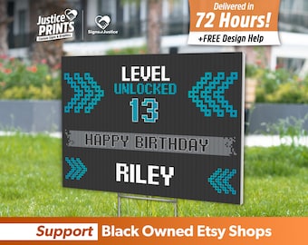 May include: A black and gray yard sign with a pixelated design. The sign says "Level Unlocked 13 Happy Birthday Riley".