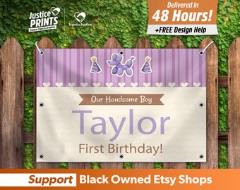 May include: Purple and white birthday banner with a balloon animal, party hats, and the text "Our Handsome Boy Taylor First Birthday!"