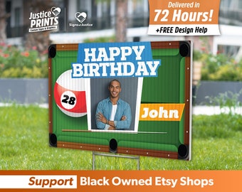 May include: A green felt pool table with a billiard ball and a photo of a person. The sign says "Happy Birthday John" and has the number 28 on the billiard ball.