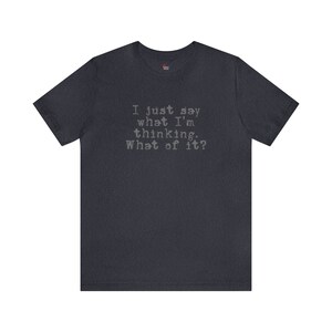 May include: A dark blue t-shirt with the text "I just say what I'm thinking. What of it?" printed in a typewriter font.