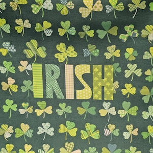 May include: Green fabric with a repeating pattern of shamrocks. The word "IRISH" is spelled out in the centre of the fabric in a patchwork style.