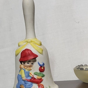 Rare find* Vintage Jasco Dinner Bell of Little Boy Pushing Wheel Borrow. Measures 5.25x2.5&quot;