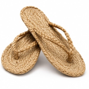 May include: A pair of tan flip-flops constructed from braided natural fiber rope. The footwear features a flat, oval-shaped sole and a braided thong strap that connects to the center of the sole, showcasing a consistent woven texture throughout.