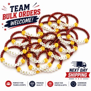 May include: A collection of beaded bracelets featuring dark red beads, yellow beads with softball patterns, and white letter beads spelling the name AMELIA. The image includes text stating TEAM BULK ORDERS WELCOME and NEXT DAY SHIPPING.
